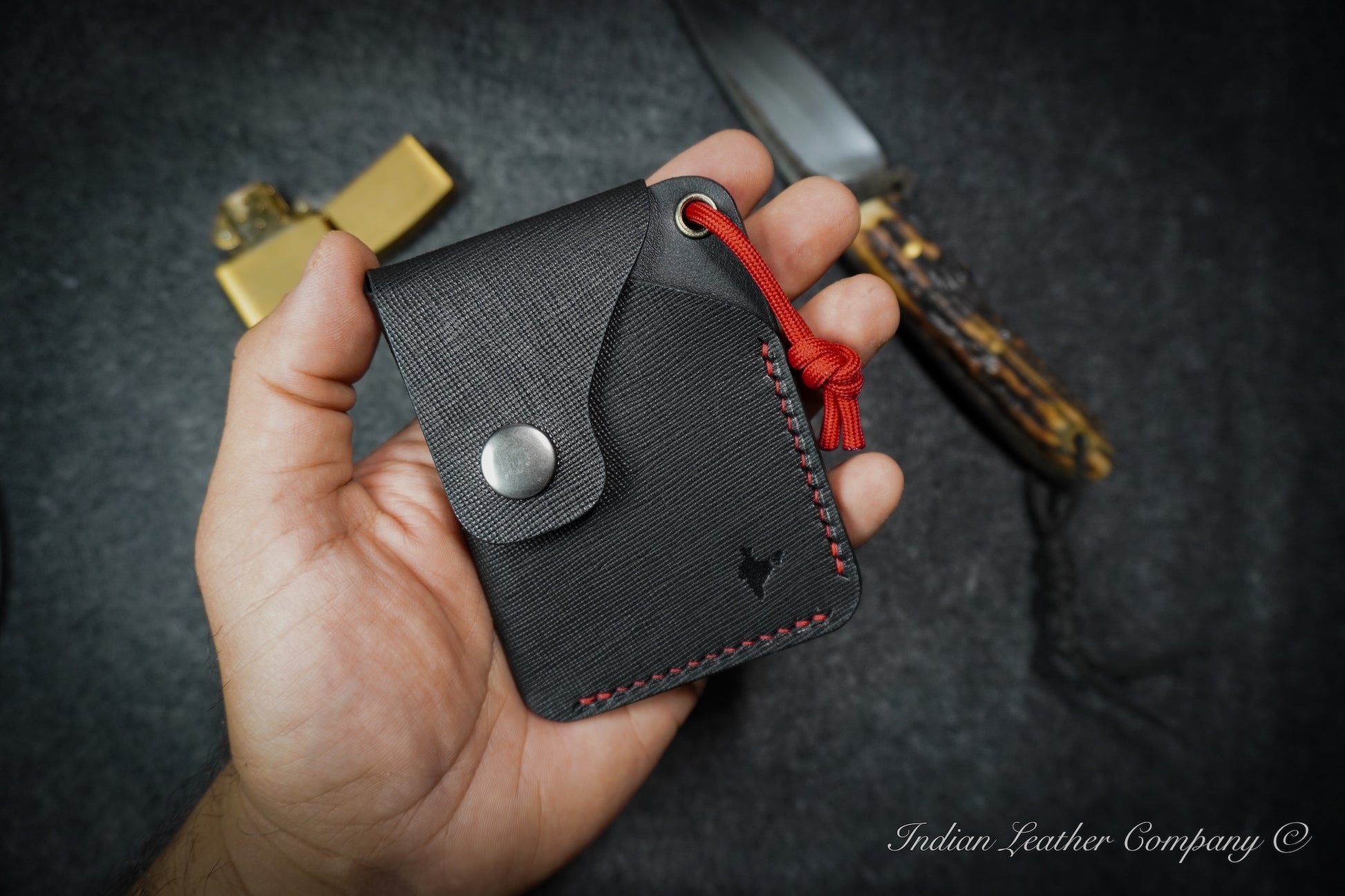 Limited edition K2 wallet with textured leather exterior, smooth interior, and stainless steel snap button closure