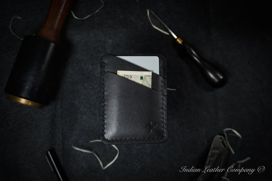 The Explorer wallet, crafted from rich Black-colored full grain Veg tanned Leather. This rugged yet refined accessory features four spacious pockets to keep your essentials organized, making it perfect for both outdoor enthusiasts and those who appreciate a touch of sophistication in their everyday carry