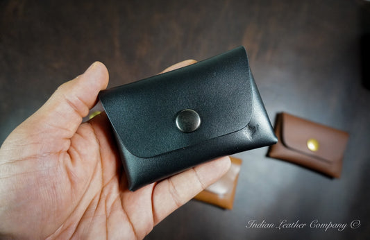 Stitchless full grain leather snap wallet with folded seamless construction and snap button closure