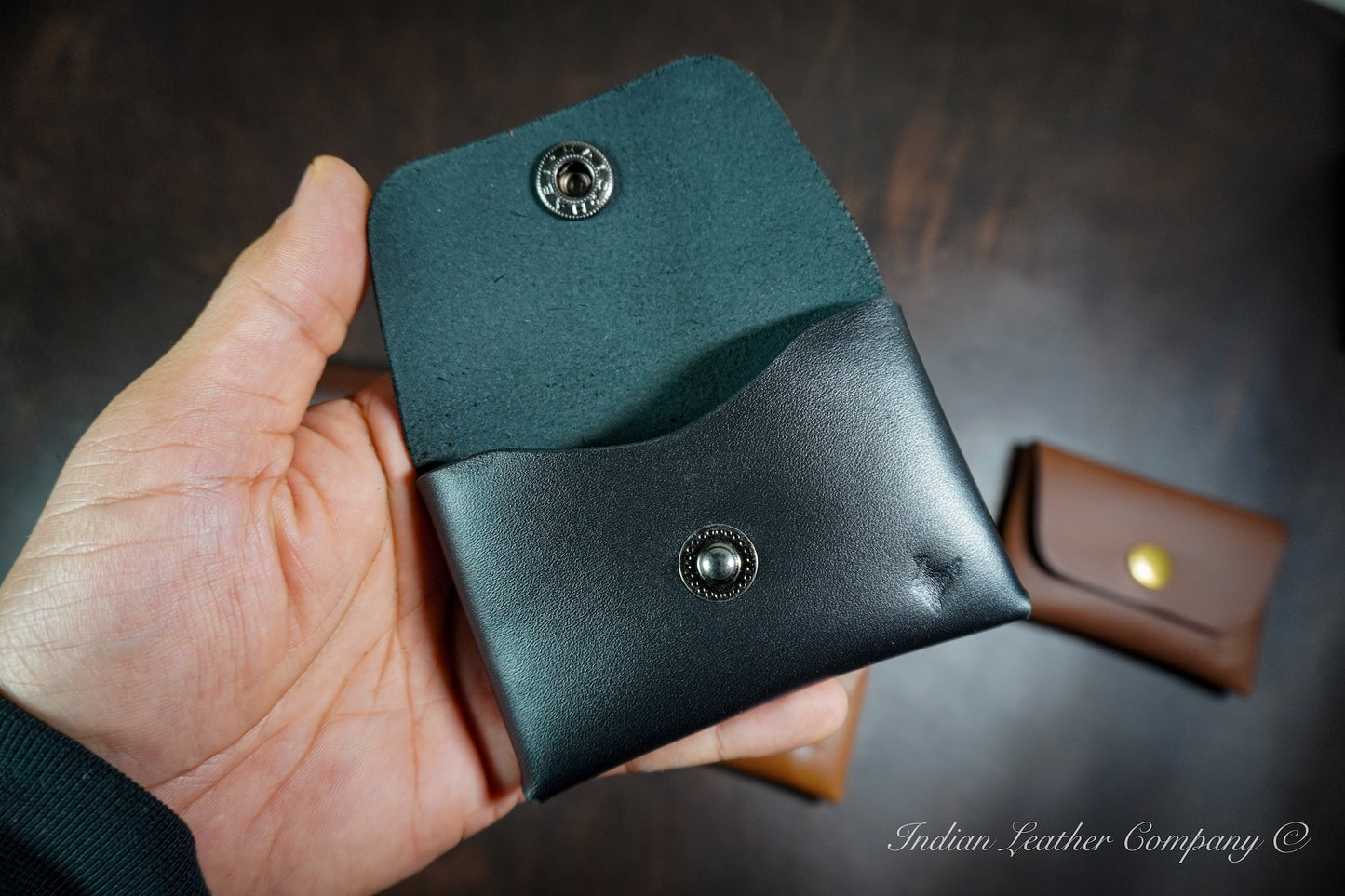 Minimalist stitchless leather wallet showing interior card pocket and folded leather construction without visible stitching