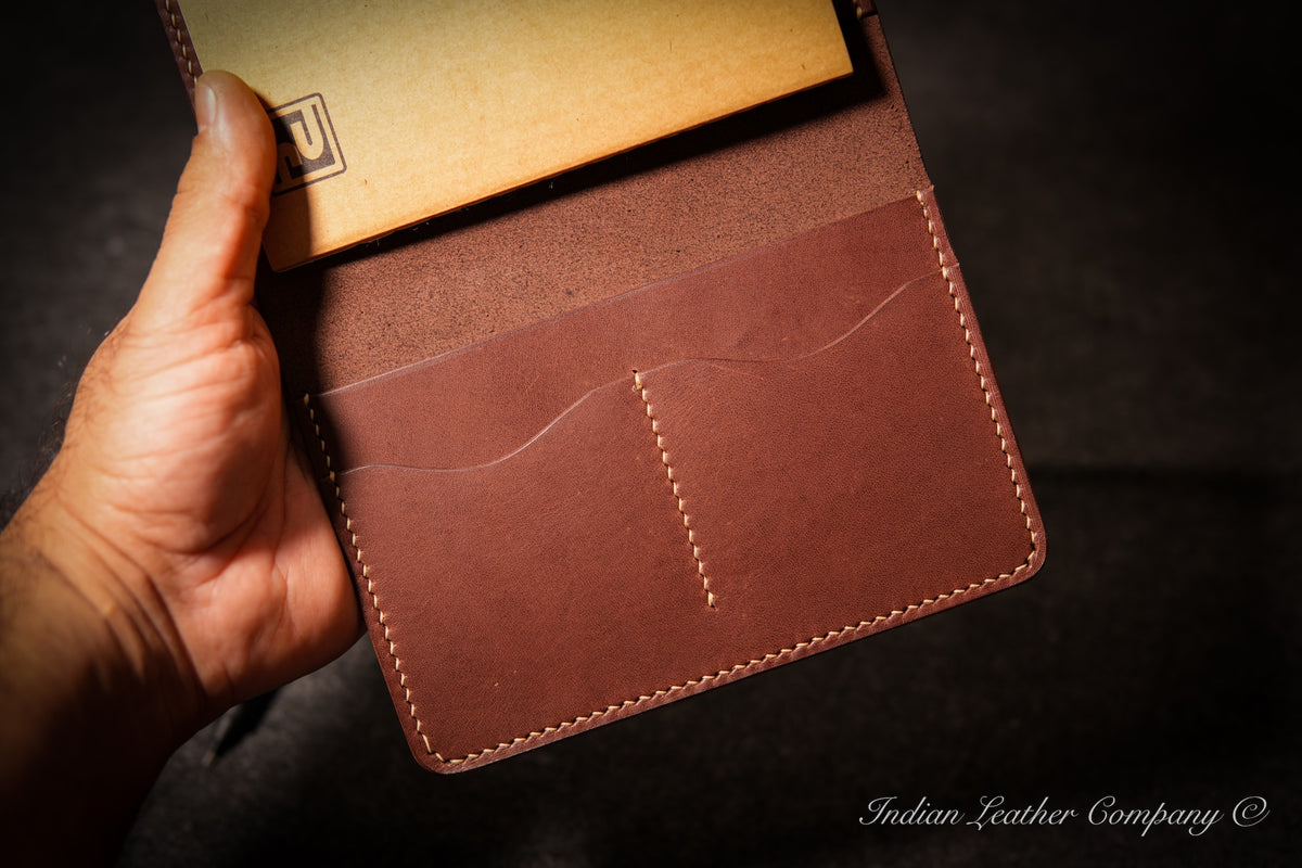 Close-up of two card slots in handmade leather journal cover