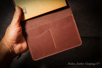 Close-up of two card slots in handmade leather journal cover
