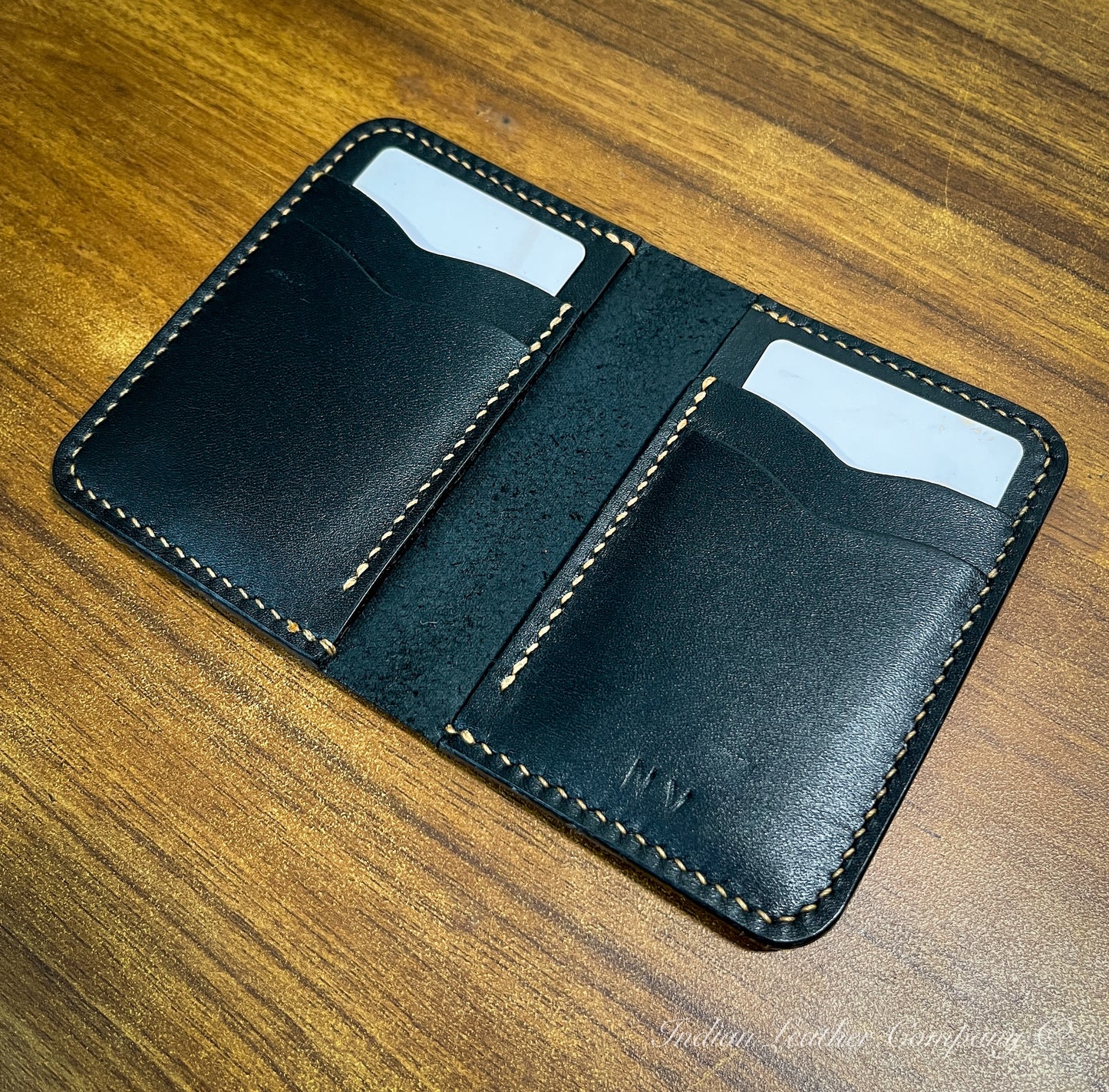 The Himalayan wallet is open with several credit cards tucked into the pockets, demonstrating its capacity and practicality while retaining its sleek design.